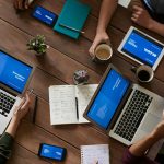 photo of people sitting near wooden table